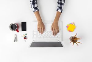 Overhead View Of Businesswoman Working At Computer In Office